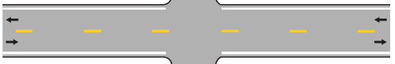 Two opposing travel directions separated by a single broken yellow center line.